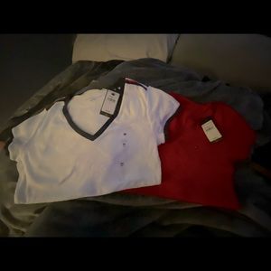 Two medium size women v neck Timmy hilfiger shirts . New with tags